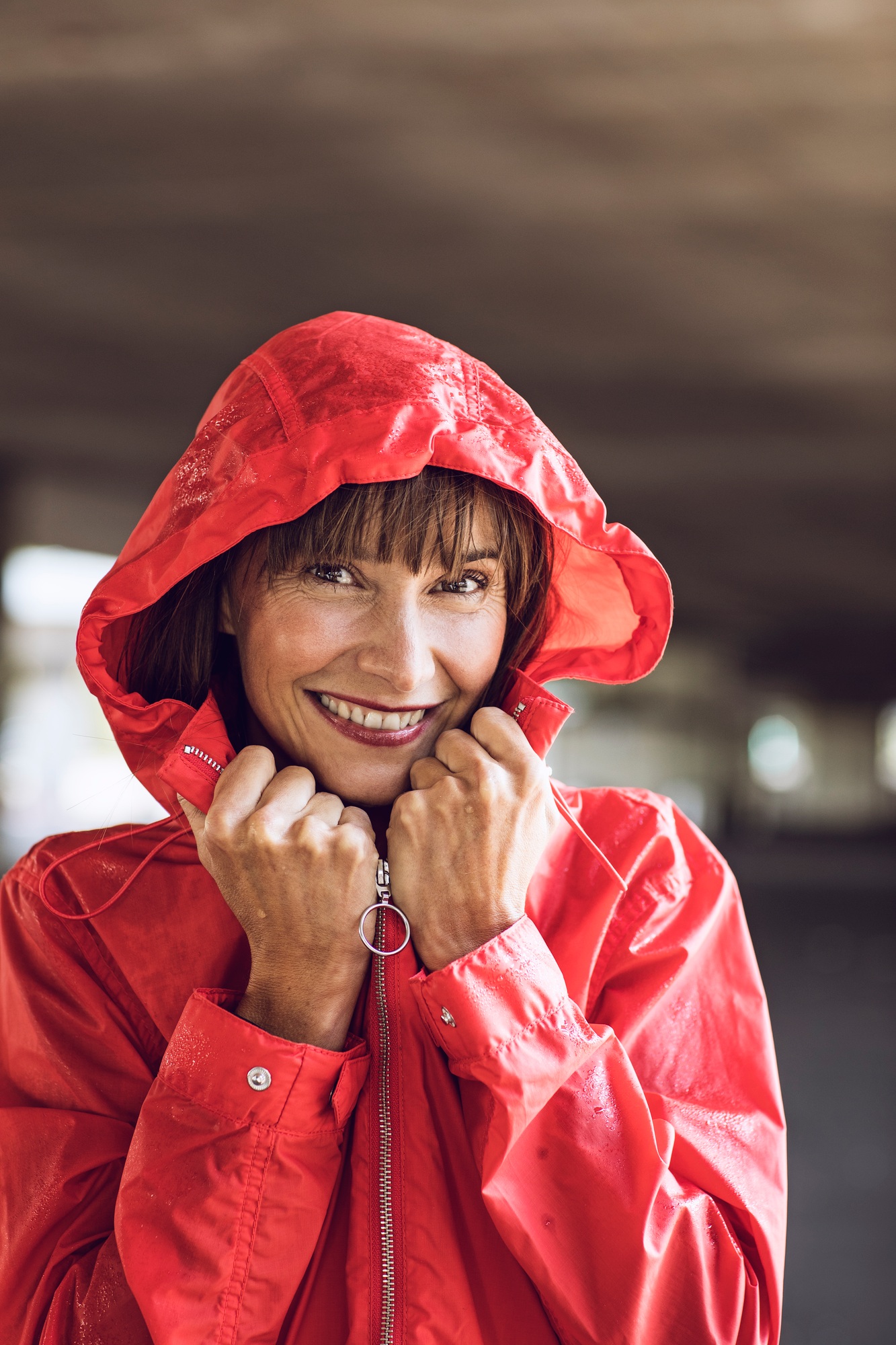 Woman wearing red rain coat, portrait